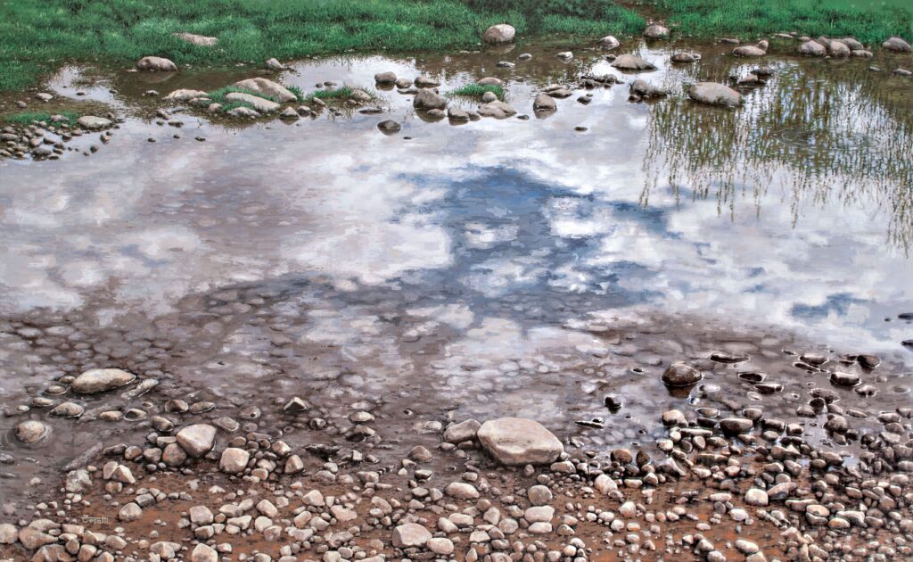 Large-scale hyperrealist acrylic painting depicting shallow water reflecting sky and clouds over stone-covered riverbed by Armando Zesatti.