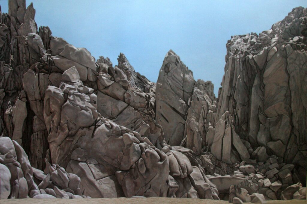 Large-scale hyperrealist acrylic painting depicting monumental rock formations and mountainous stone landscape under clear sky by Armando Zesatti