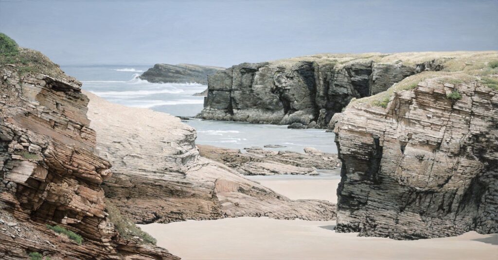 Large-scale hyperrealist acrylic painting depicting dramatic coastal cliffs and sandy shoreline with ocean waves by Armando Zesatti